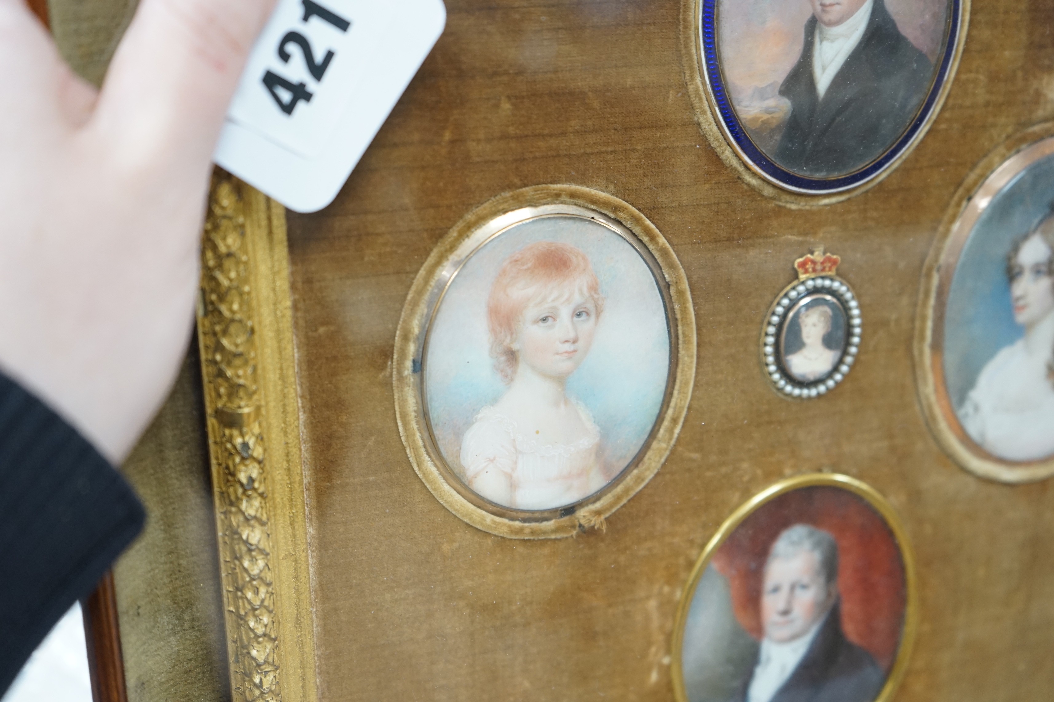 A group of five 19th century portrait miniatures on ivory, framed as one, in a decorative gilt and velvet mount rosewood frame. Overall 36 x 32cm